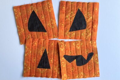black and orange fabric on table in shape of pumpkin face- during construction
