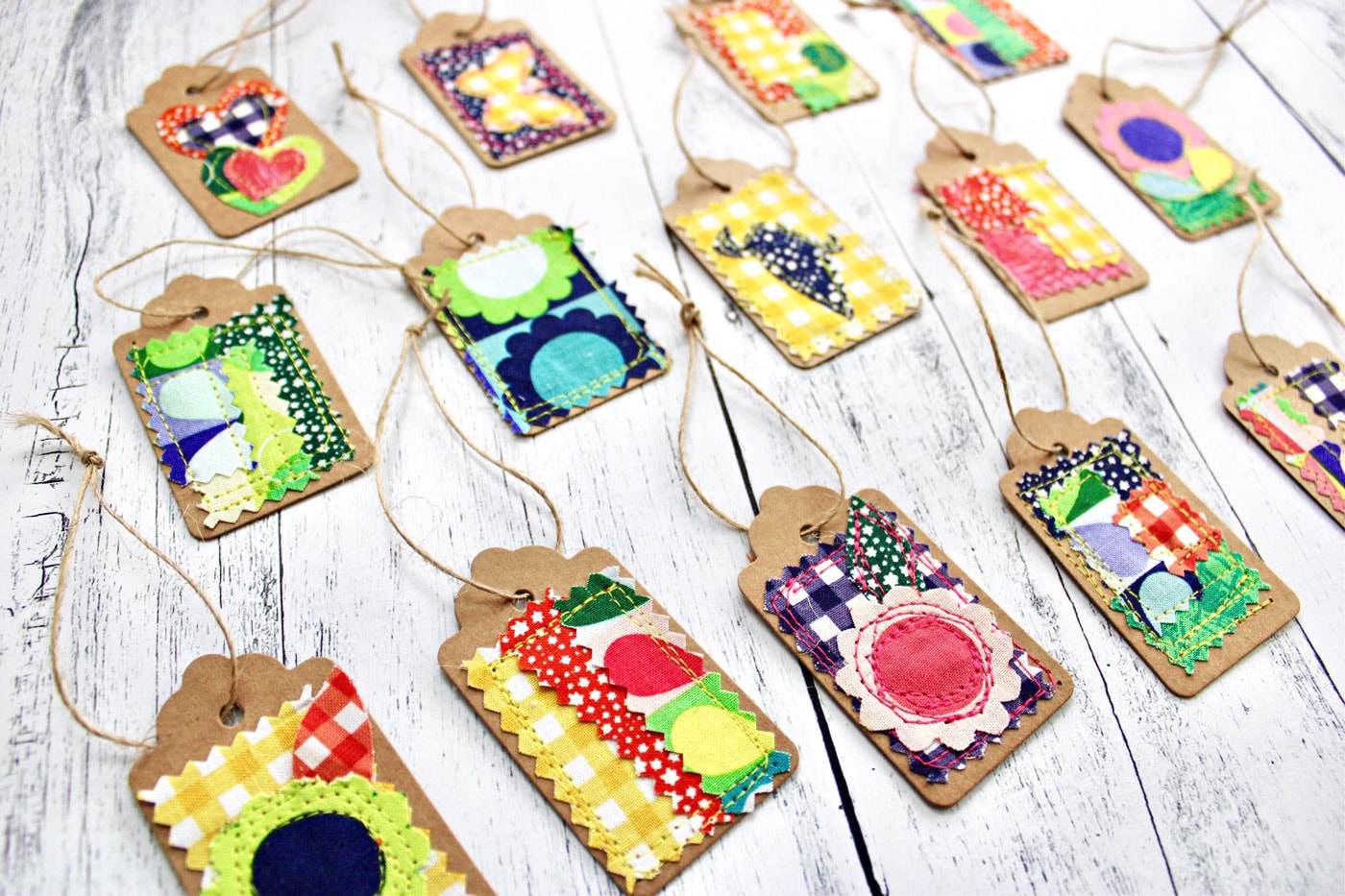 colorful fabric and paper gift tags on white wood table