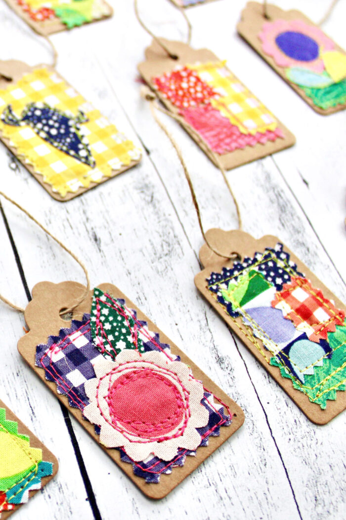 colorful fabric and paper gift tags on white wood table