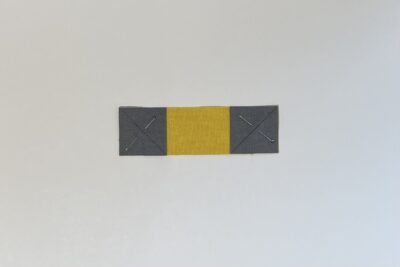 gray and yellow fabrics on white table