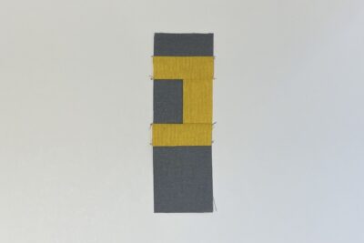 gray and yellow fabrics on white table