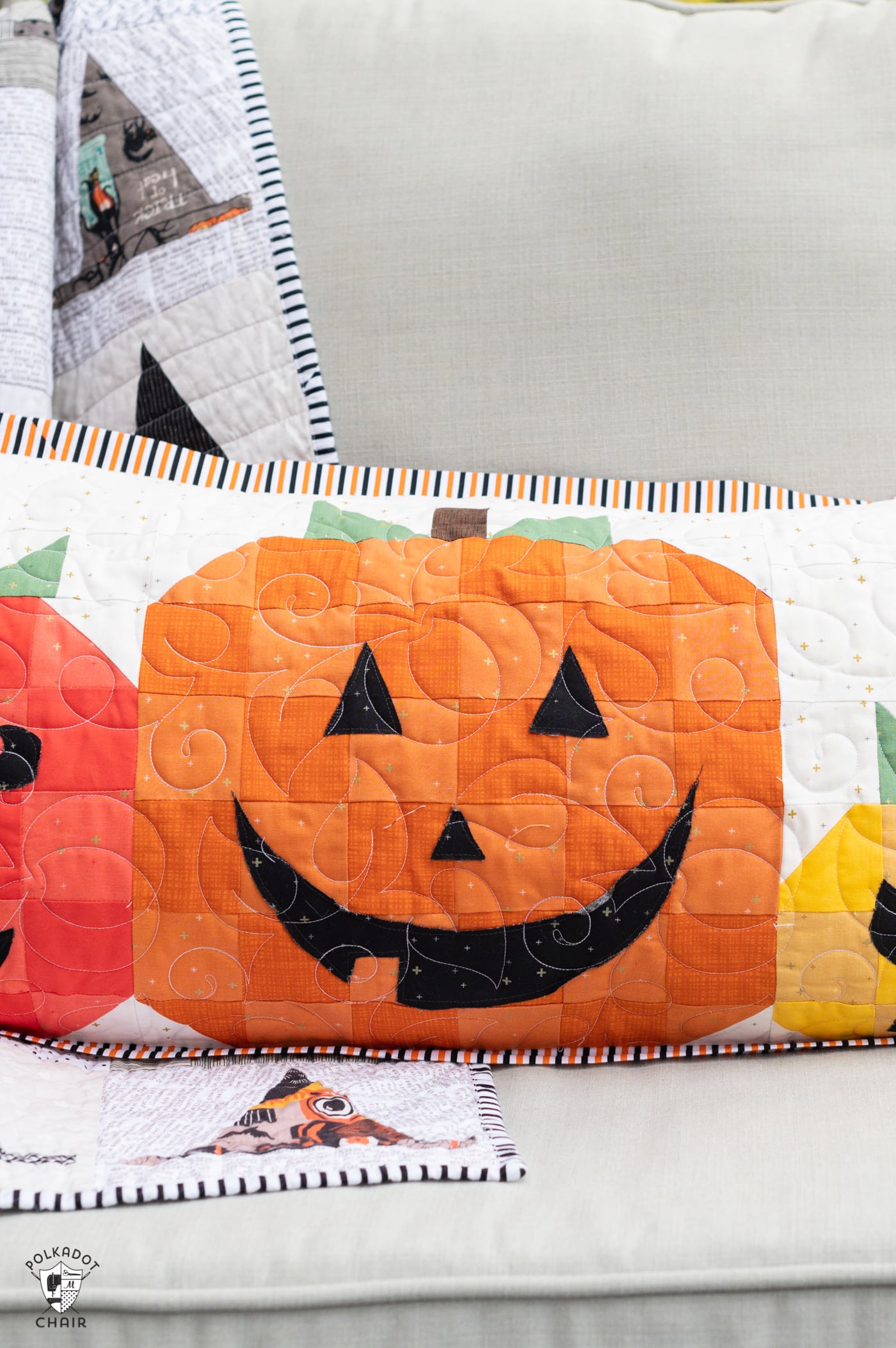 quilted pillow with 5 pumpkins outdoors