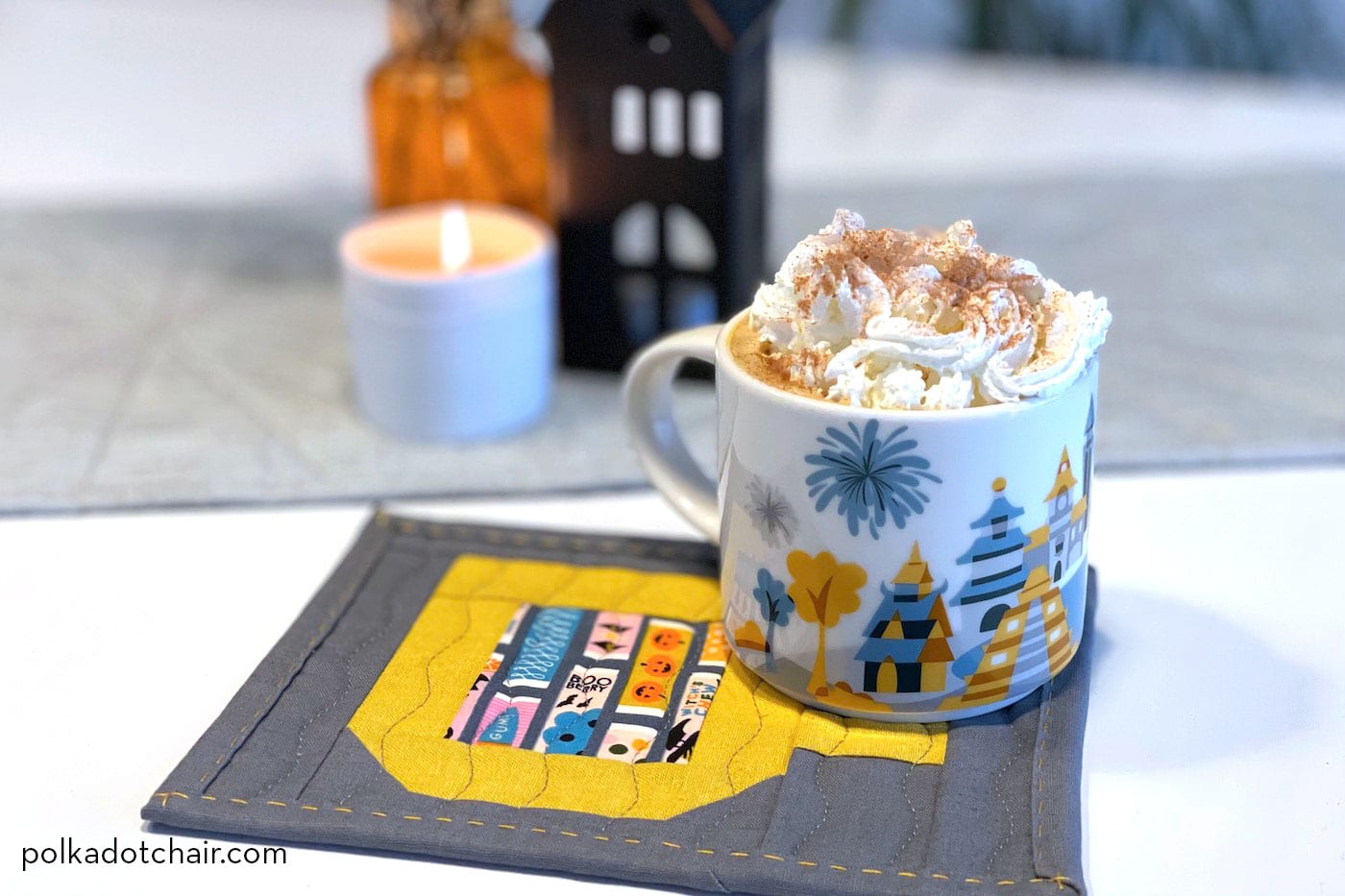 quilted mug rug pattern on table with cup of hot chocolate