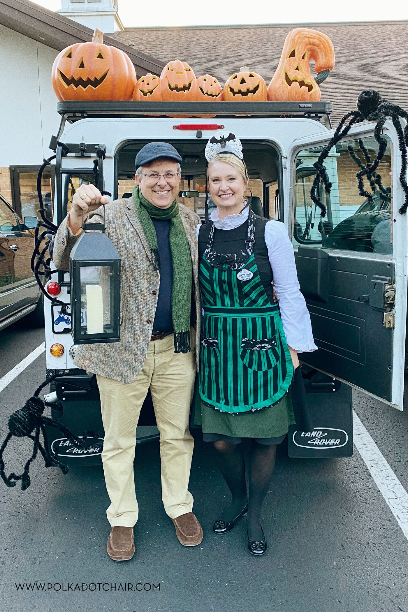 couple dressed up as Haunted mansion characters in front of white suv