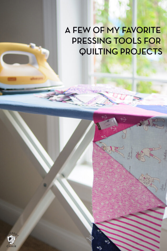 iron and ironing board near window with fabric