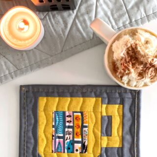 quilted mug rug pattern on table with cup of hot chocolate