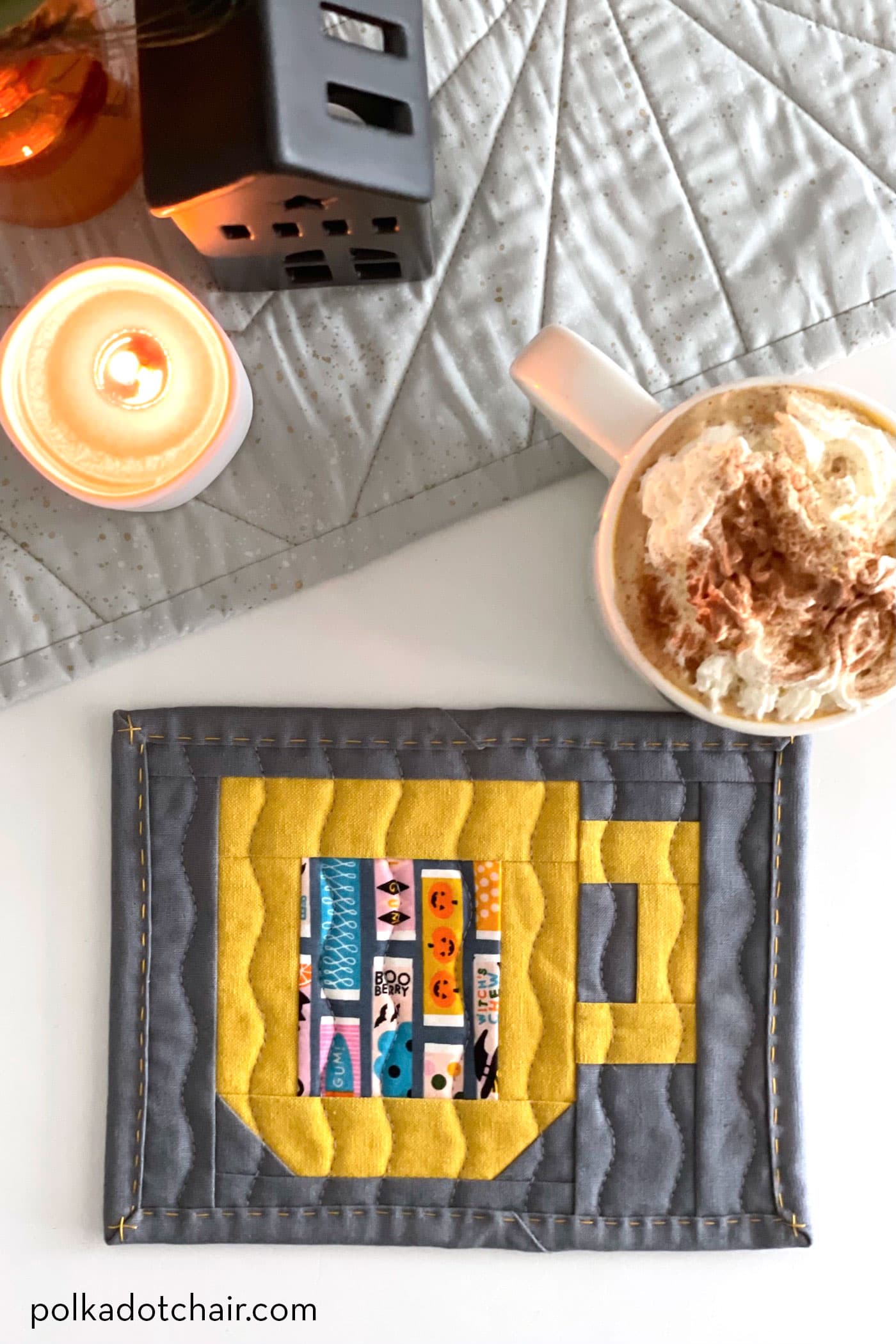 quilted mug rug pattern on table with cup of hot chocolate