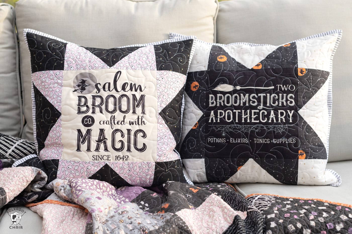 two black and white pillows on couch outdoors with halloween quilt