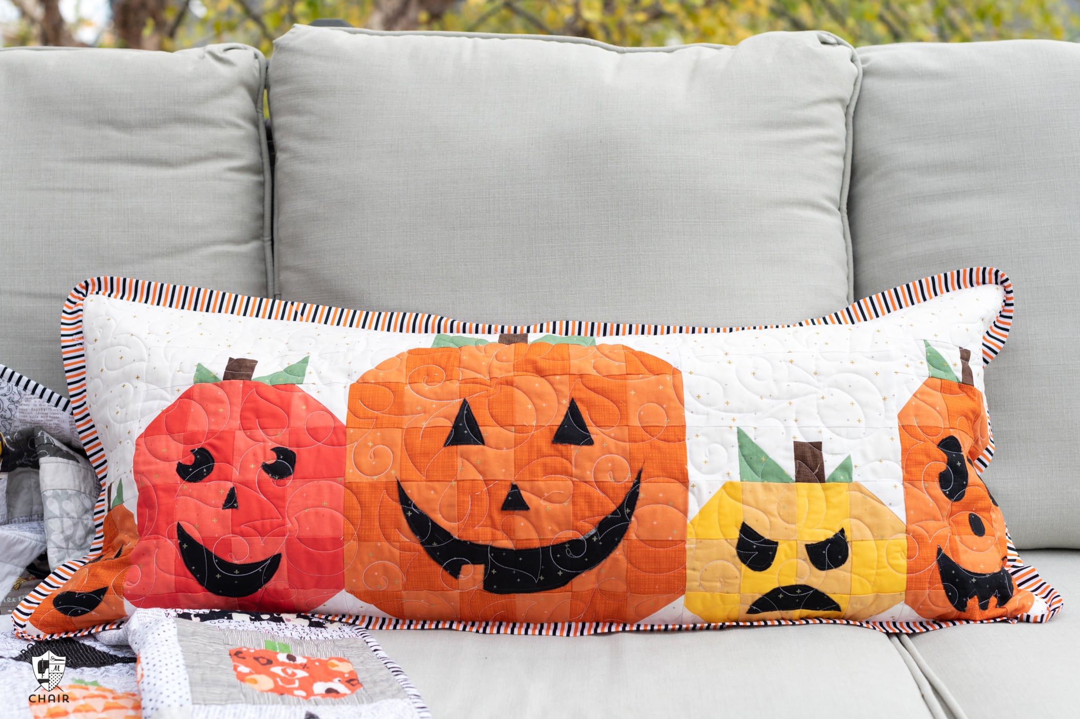 quilted pillow with 5 pumpkins outdoors