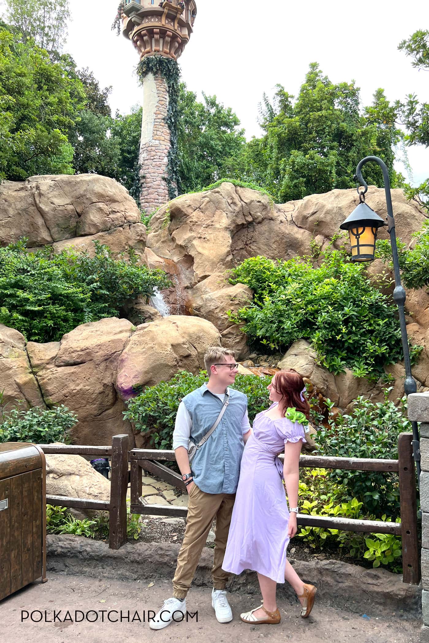 man and woman dressed up in rapunzel costumes at disneyworld