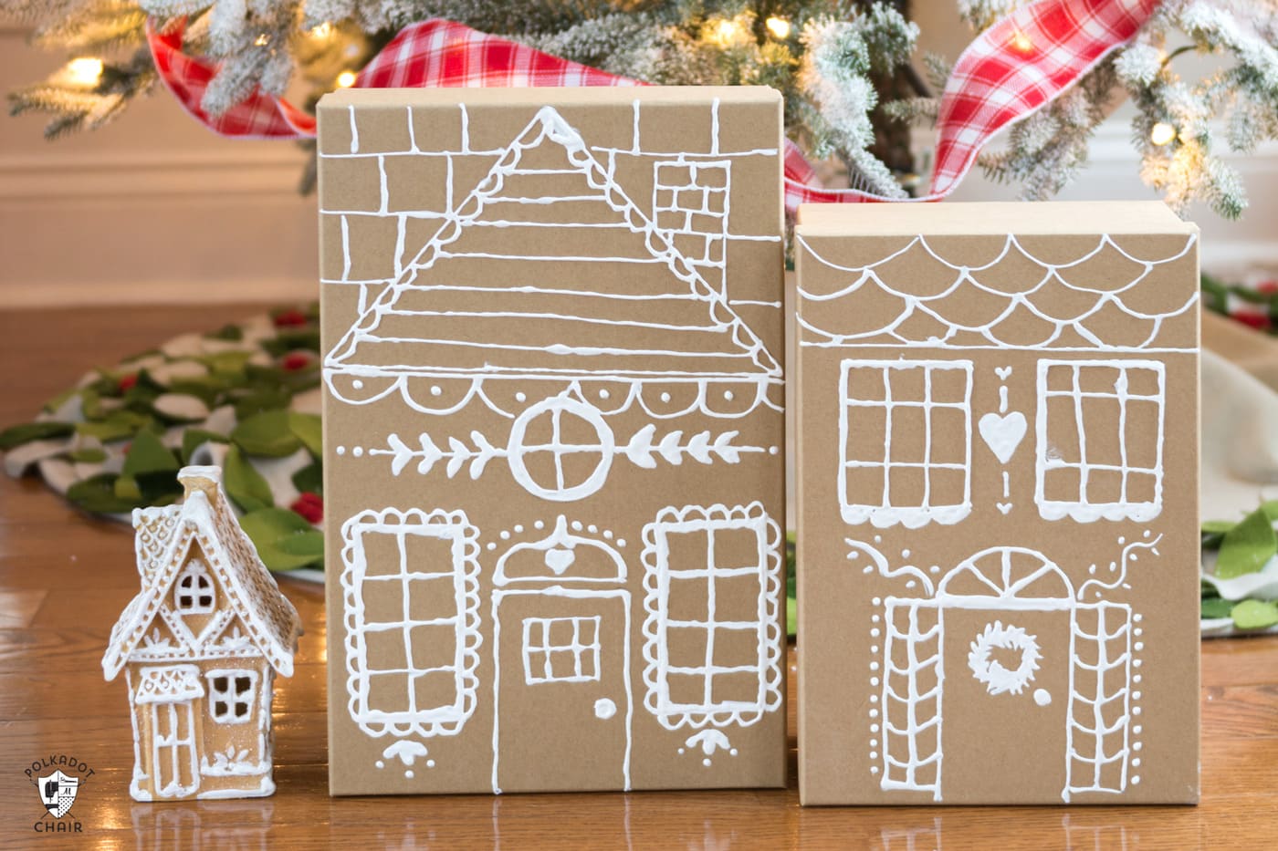 Gingerbread house paper gift boxes in front of the Christmas tree