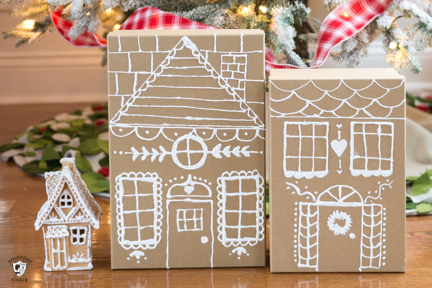 paper gingerbread house gift boxes in front of christmas tree