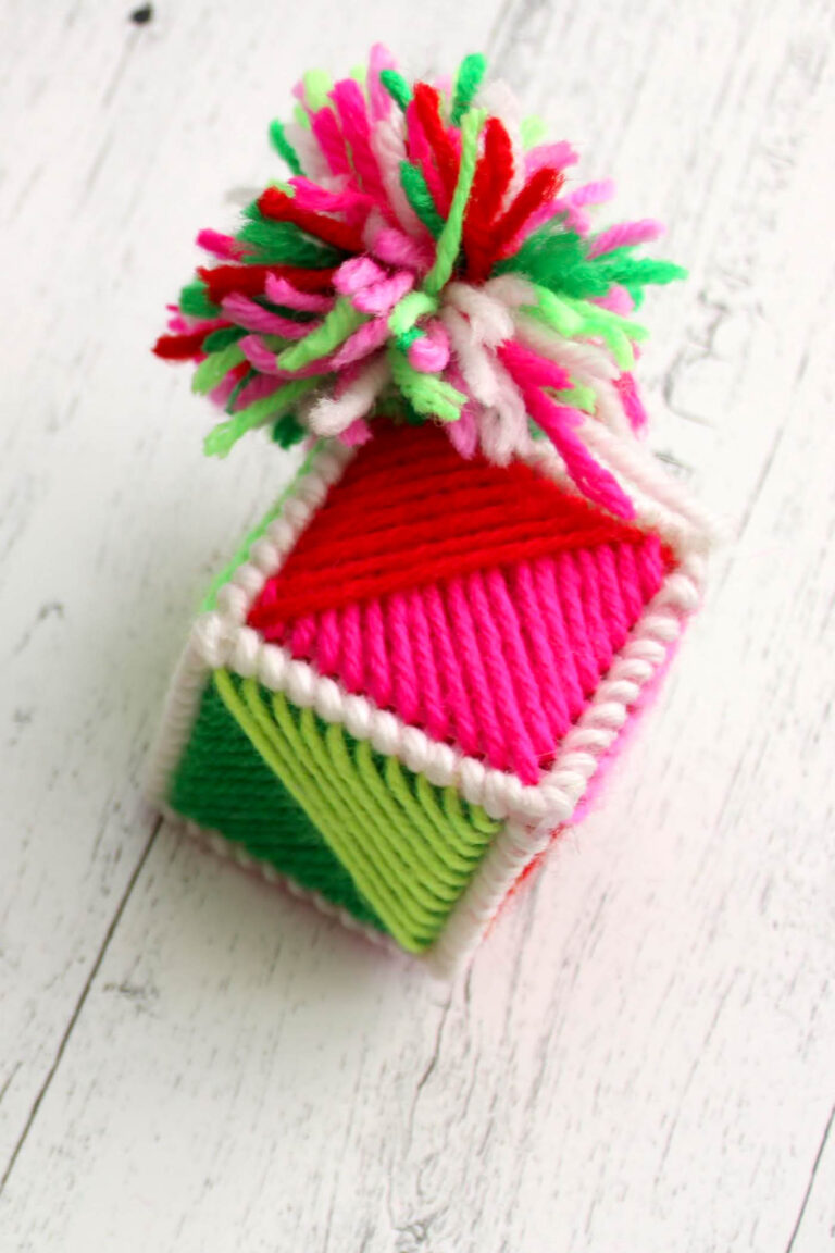 colorful yarn ornament on white wood table