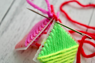 colorful yarn and plastic canvas ornament construction steps