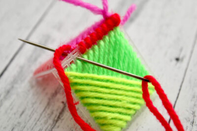 colorful yarn and plastic canvas ornament construction steps