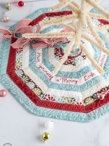 striped mini tree skirt on white marble table with ornaments