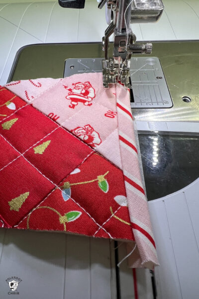 pink and red Christmas stocking in construction process on white cutting mat