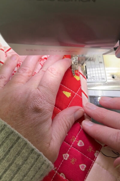 colorful stocking under foot of sewing machine