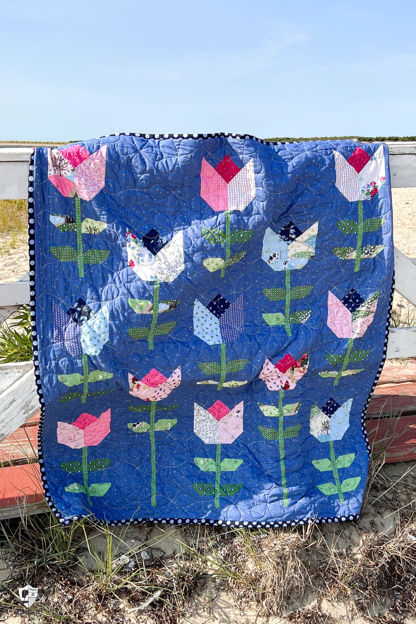 blue tulip quilt on beach