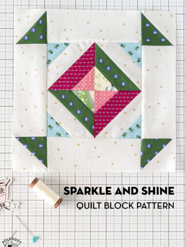pink, green and blue quilt block pattern on white cutting mat