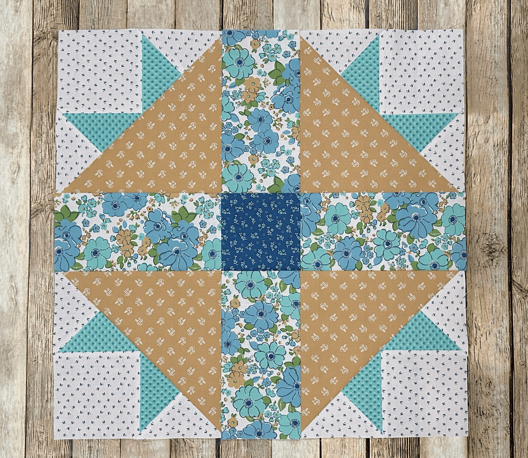 yellow and blue quilt block on wood table