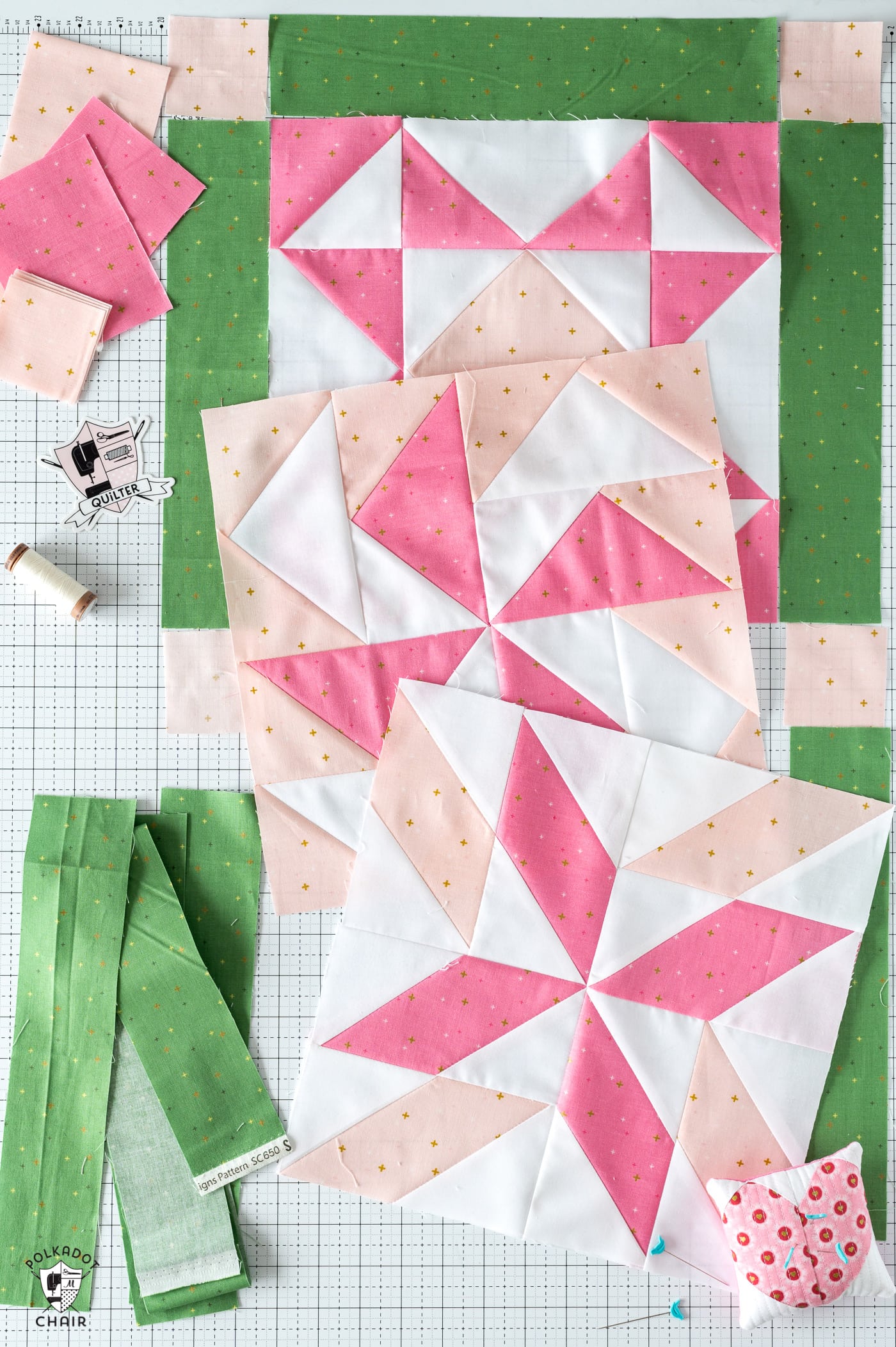 Pink and white quilt blocks on cutting mat with green fabric