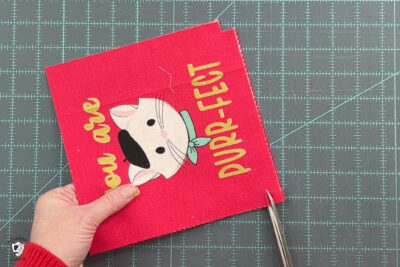 red fabric on cutting mat with ruler and scissors