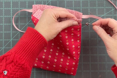 red fabric on cutting mat with ribbon