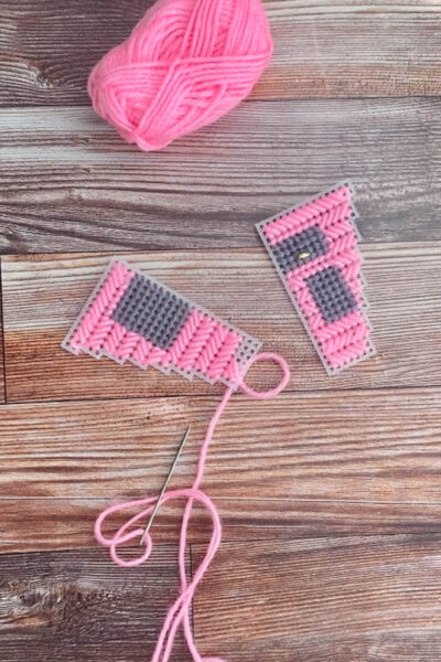 pink and gray yarn on wood table