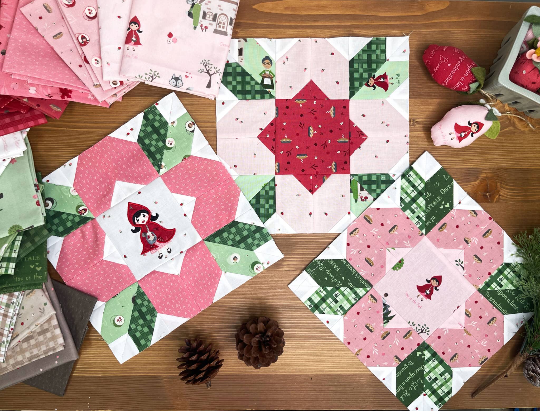 colorful pink and green quilt blocks on wood table
