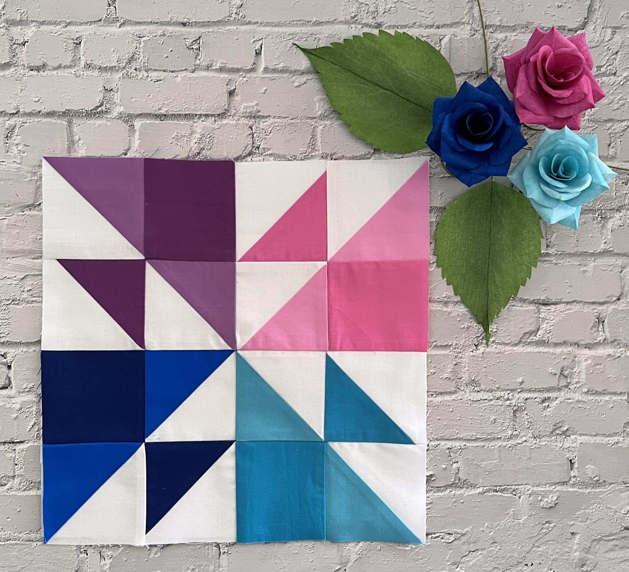 pink, blue and purple quilt block on brick table