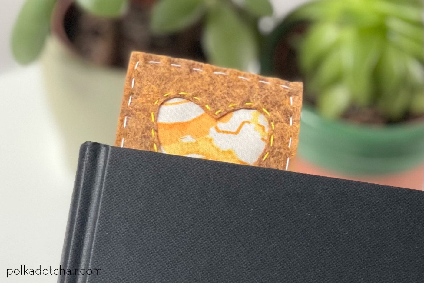 brown, green and yellow bookmark on book in room with plants