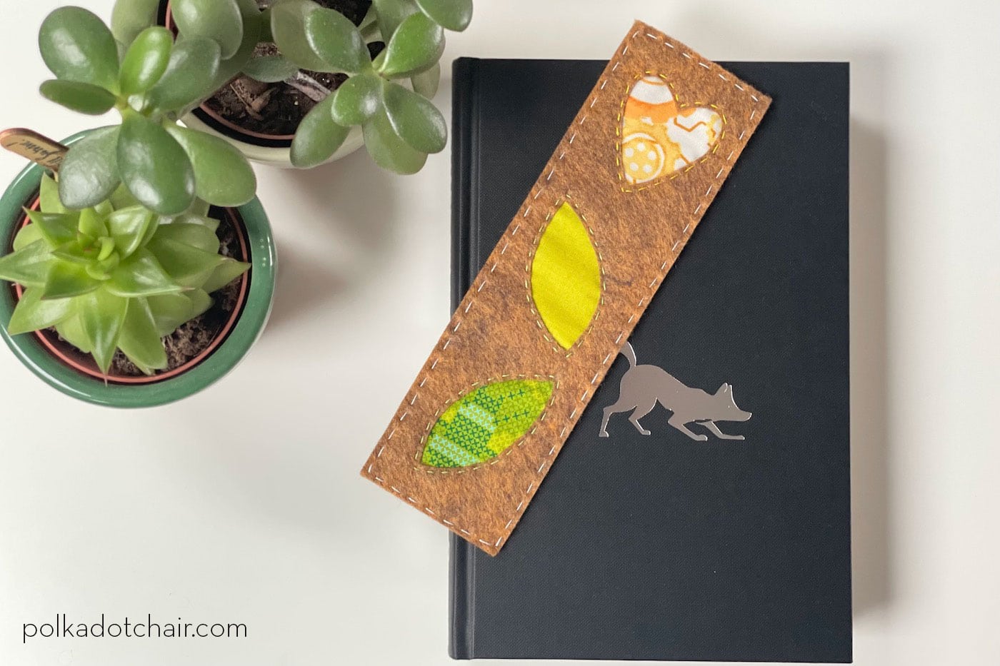 brown, green and yellow bookmark on book in room with plants