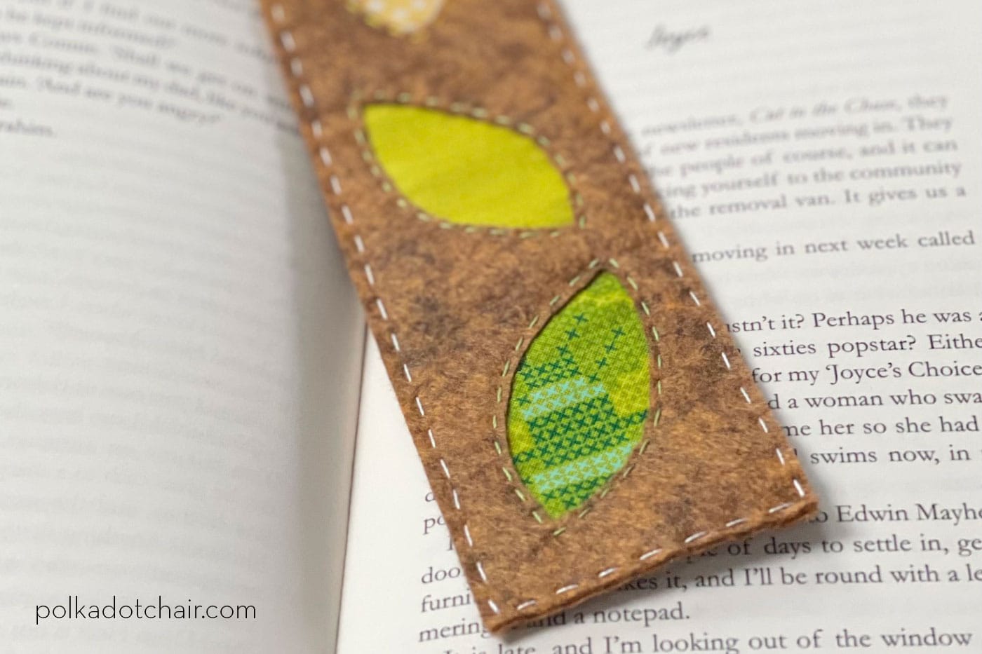 brown, green and yellow bookmark on book in room with plants