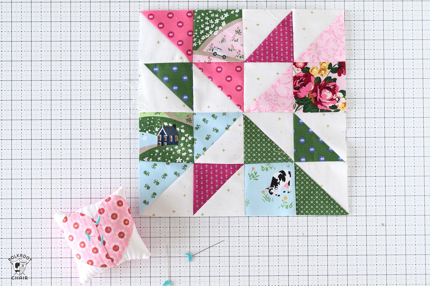 blue, green and pink quilt block on cutting mat