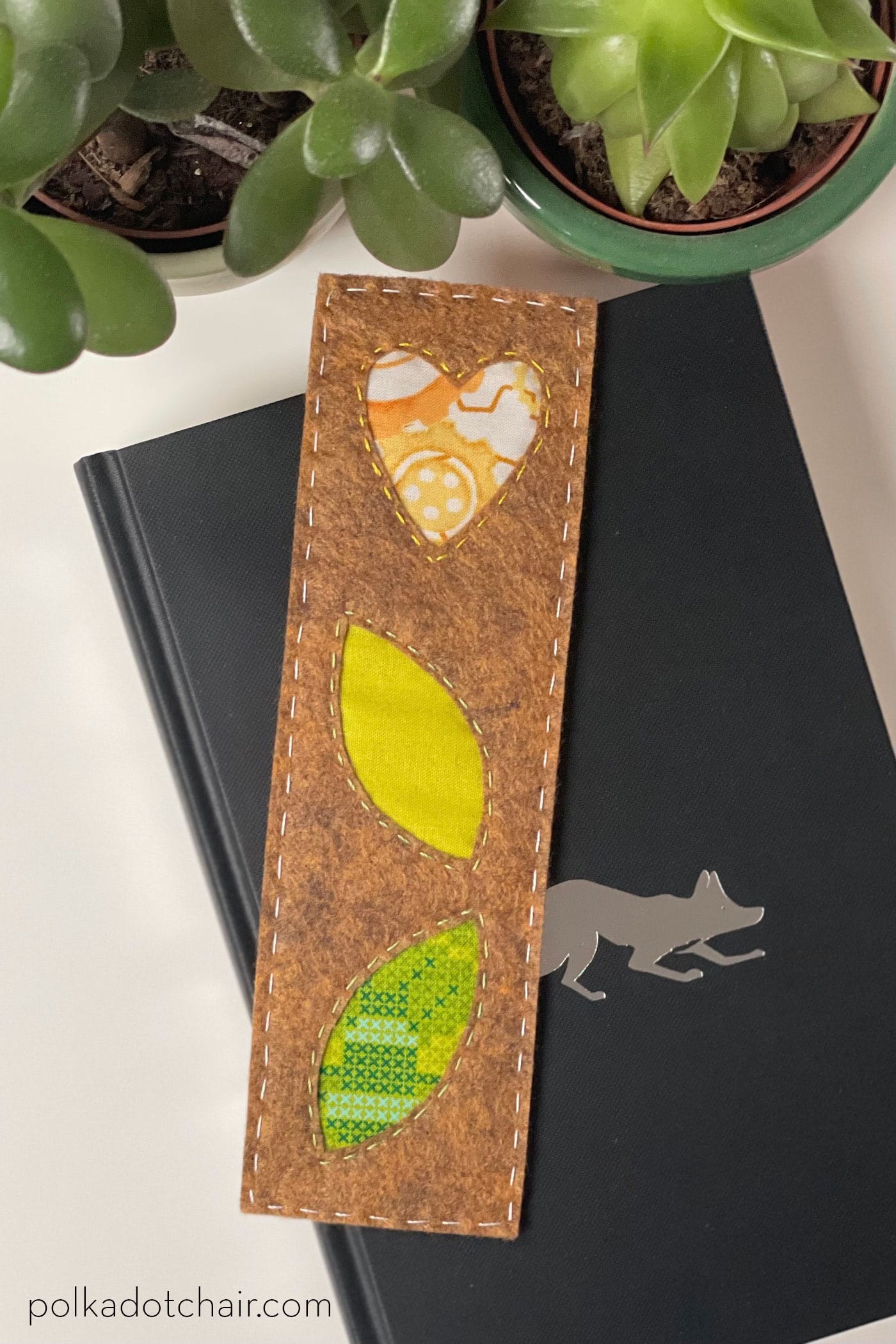 brown, green and yellow bookmark on book in room with plants