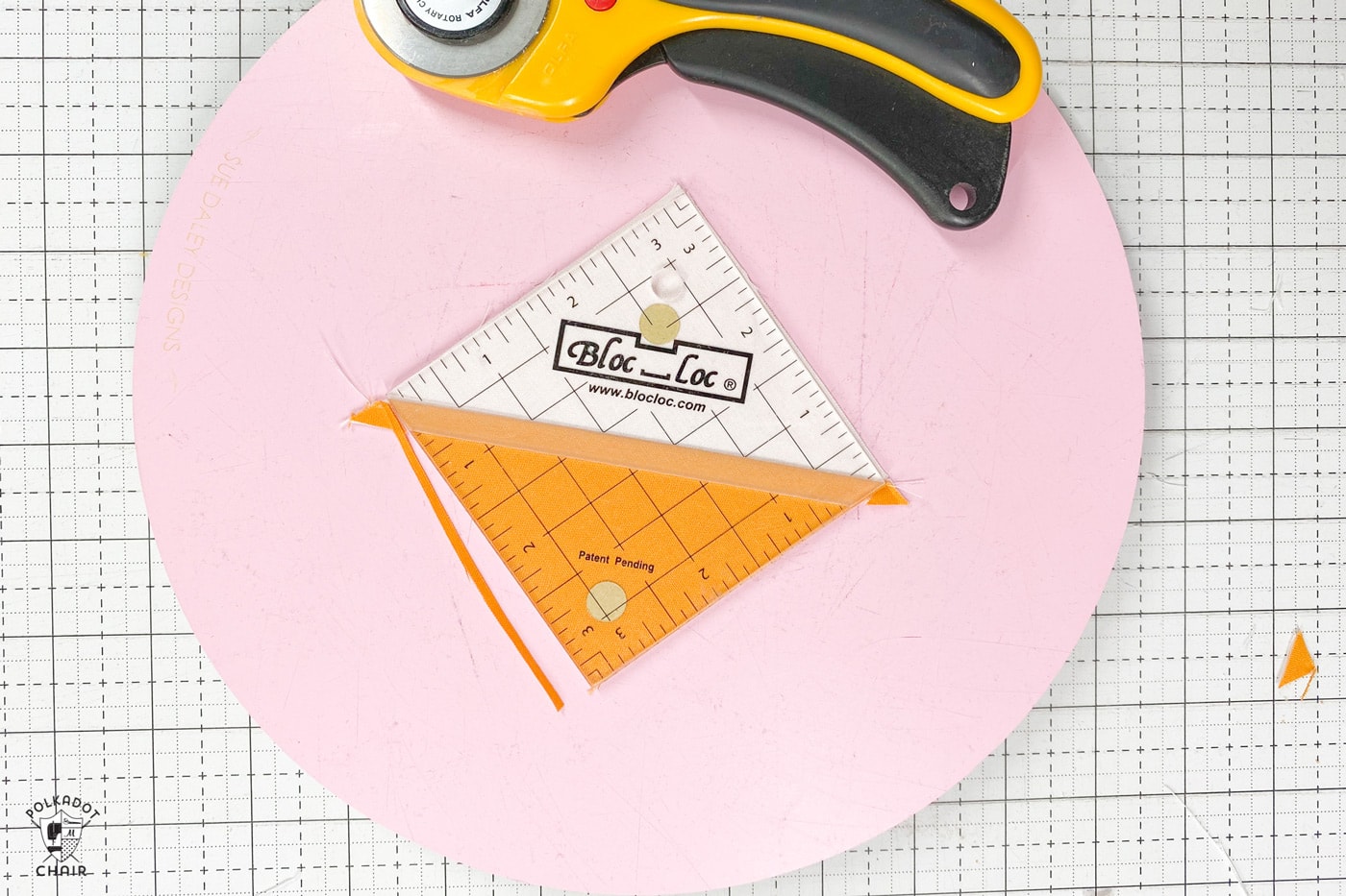 quilt ruler on top of yellow and white quilt block