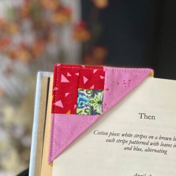 pink and red fabric bookmark on corner of book