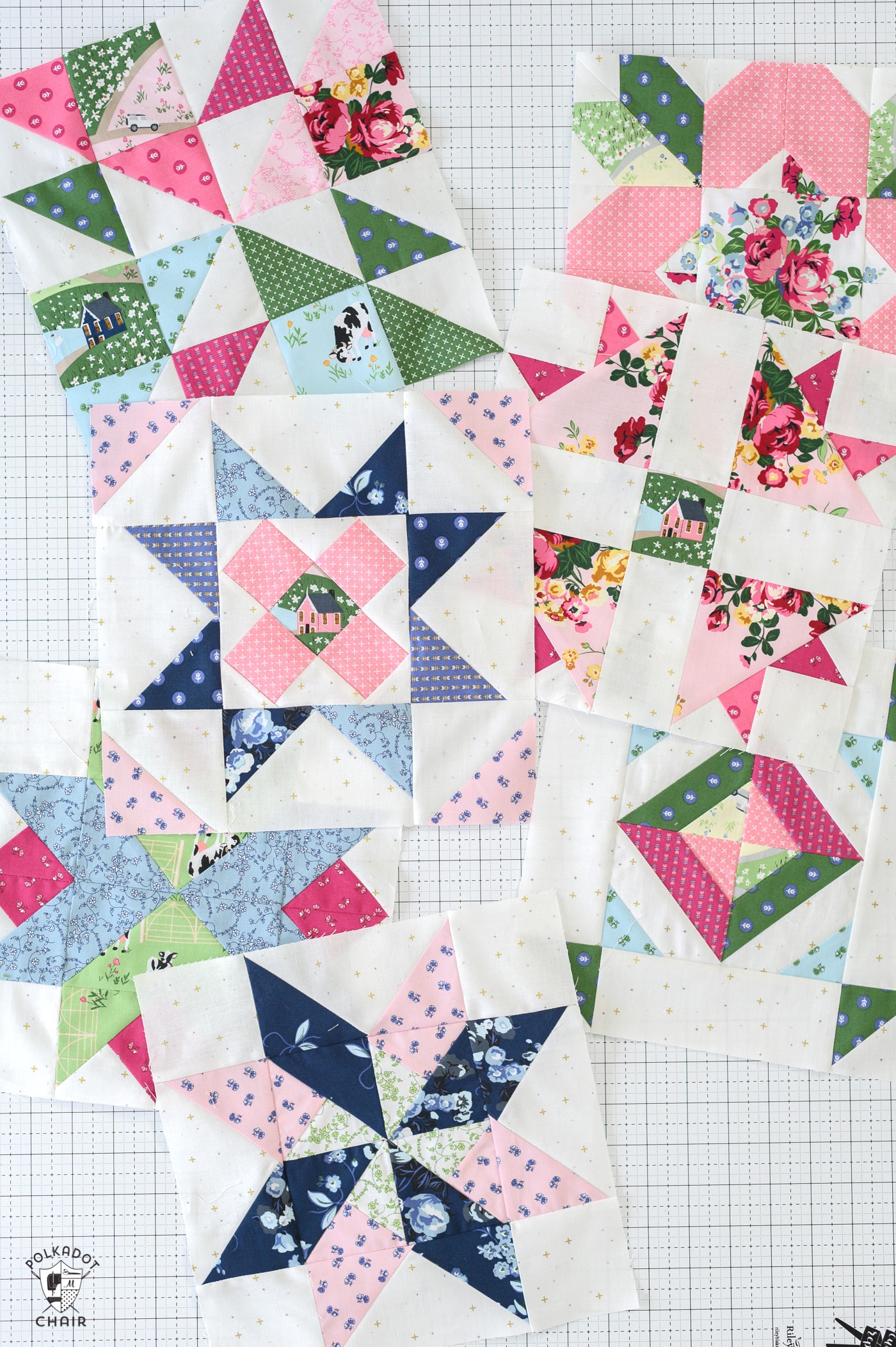 Pink, blue and green quilt blocks on white cutting mat