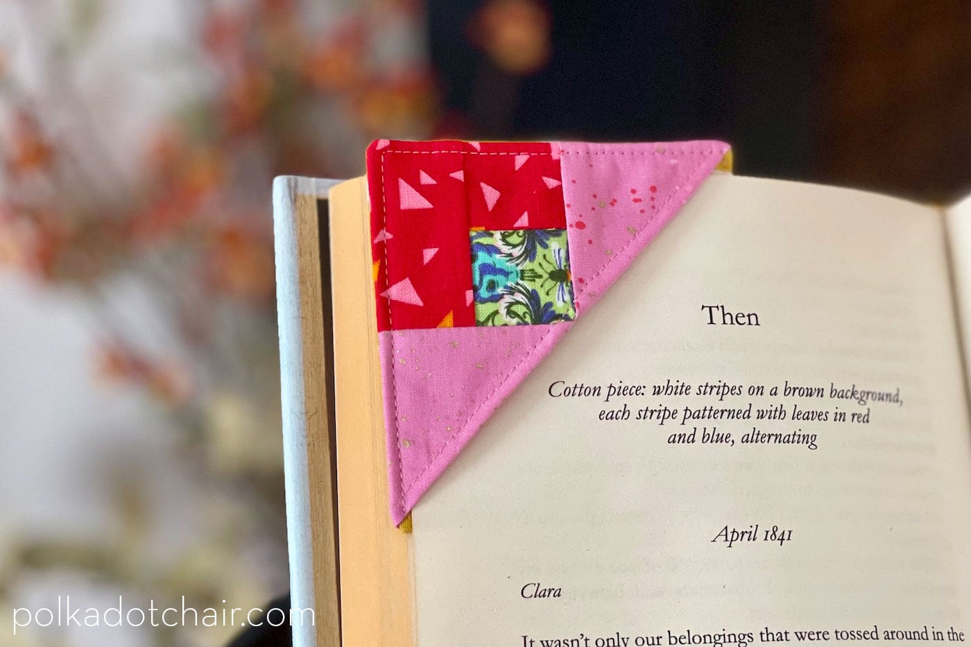 pink and red corner bookmark on corner of book page