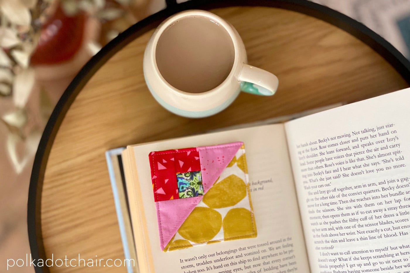 pink and red corner bookmark on corner of book page with coffee mug