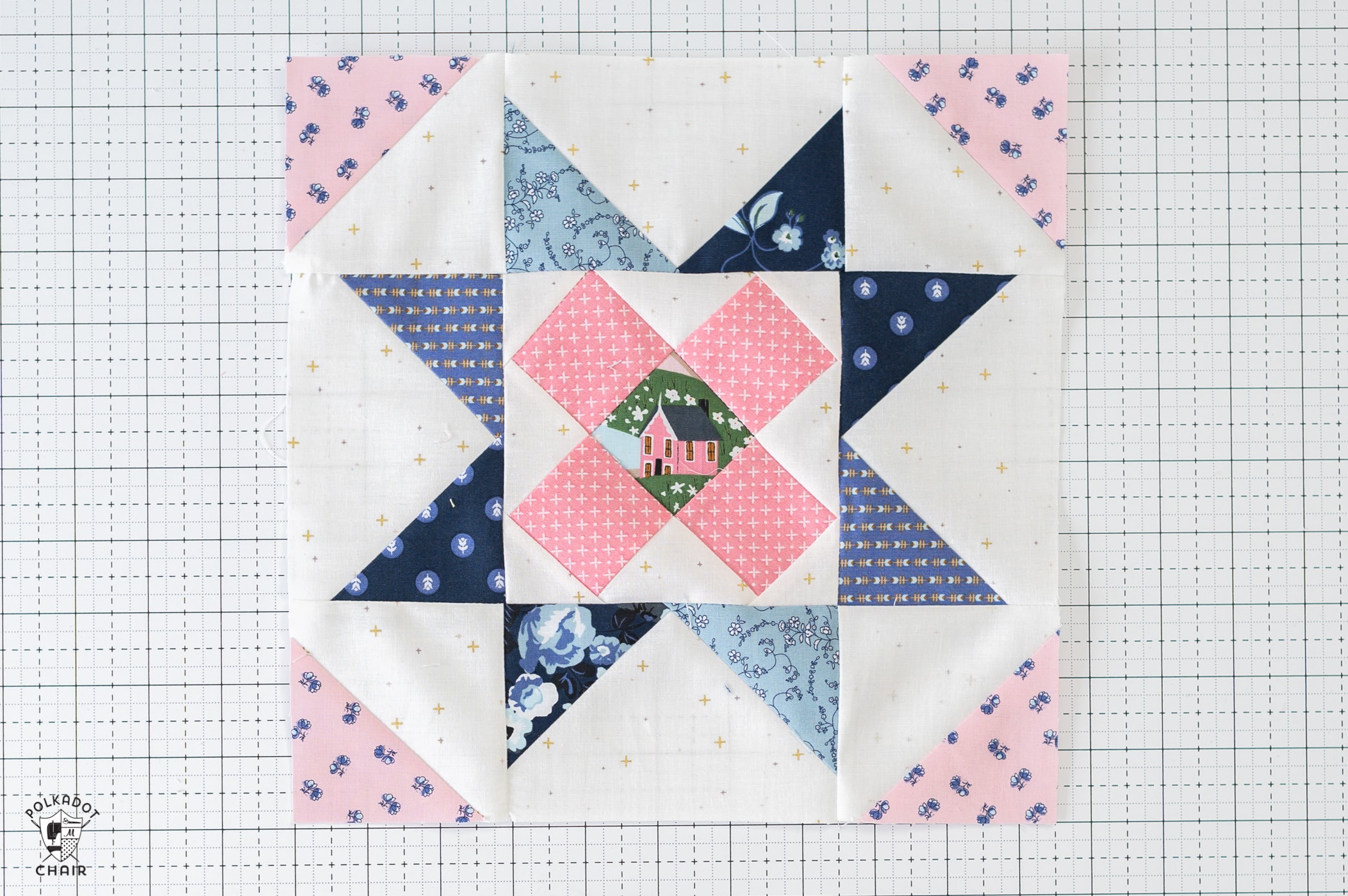 Blue and pink quilt block on white cutting mat