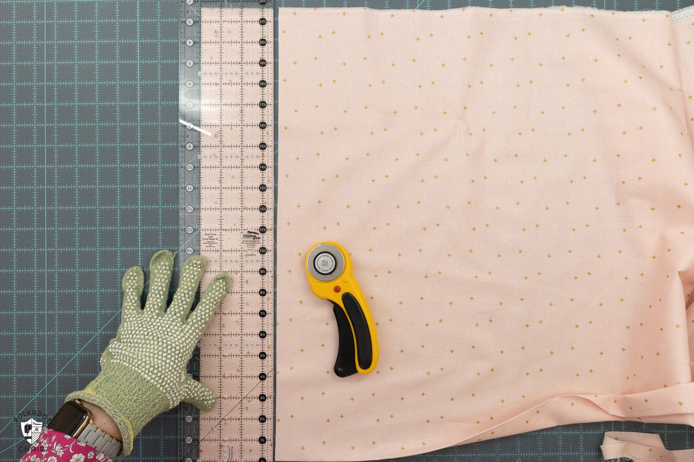 pink fabric being cut on blue cutting mat