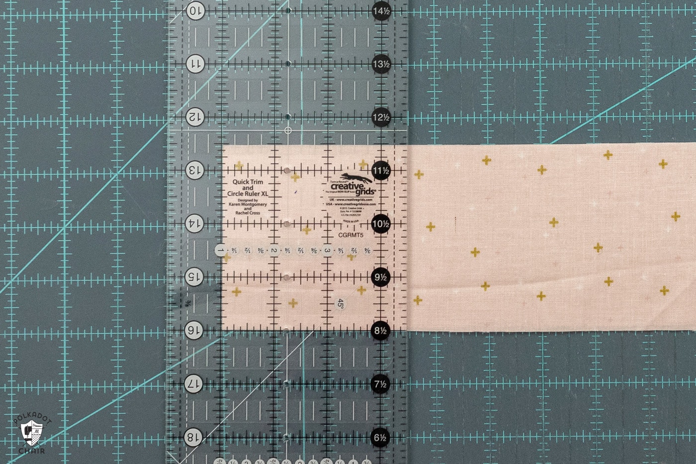 pink fabric being cut on blue cutting mat