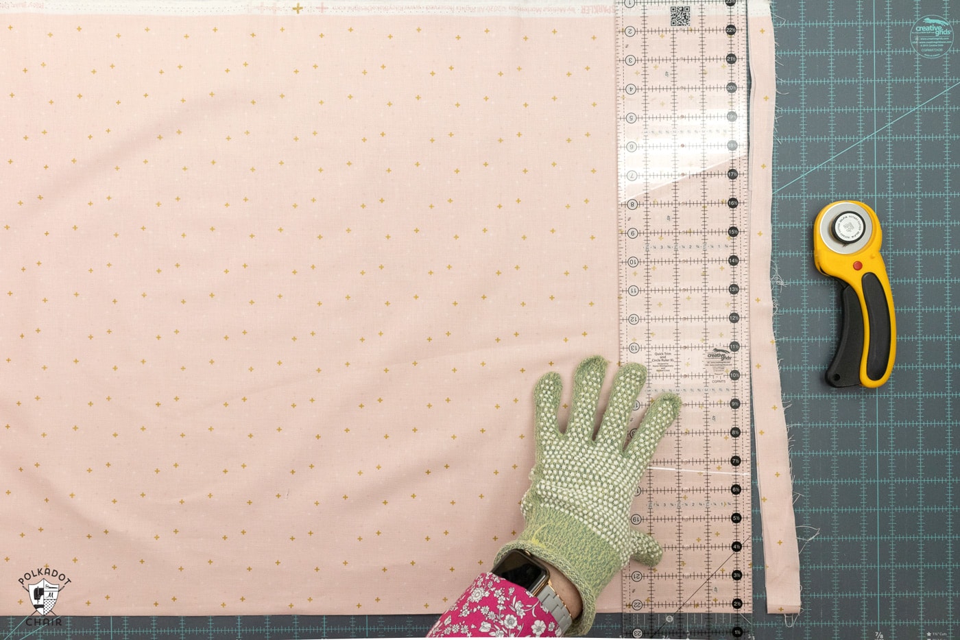 pink fabric being cut on blue cutting mat