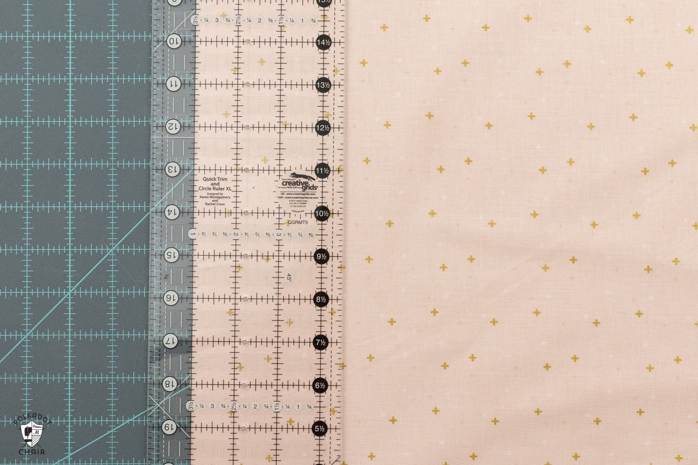 pink fabric being cut on blue cutting mat