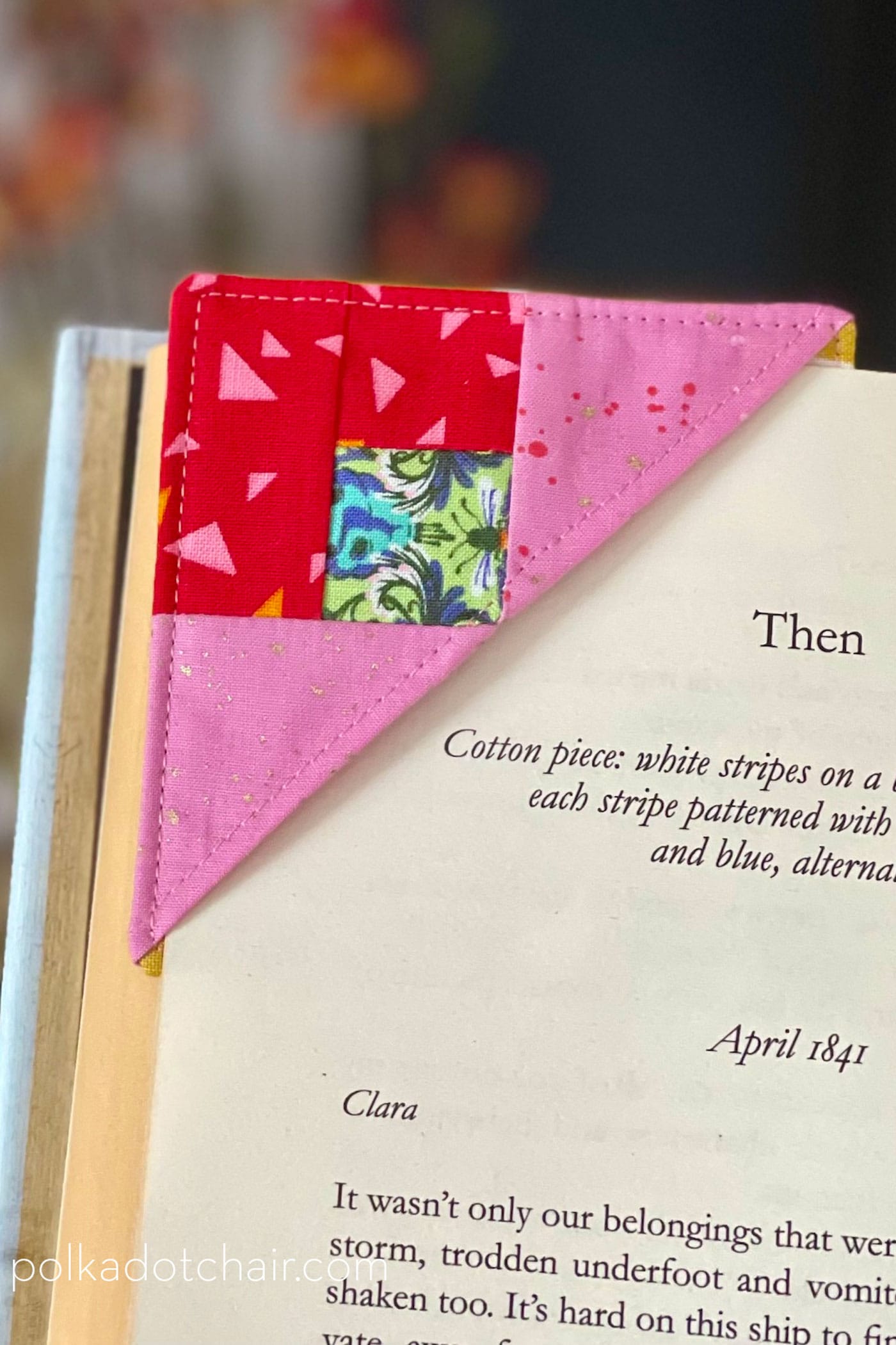 pink and red corner bookmark on corner of book page