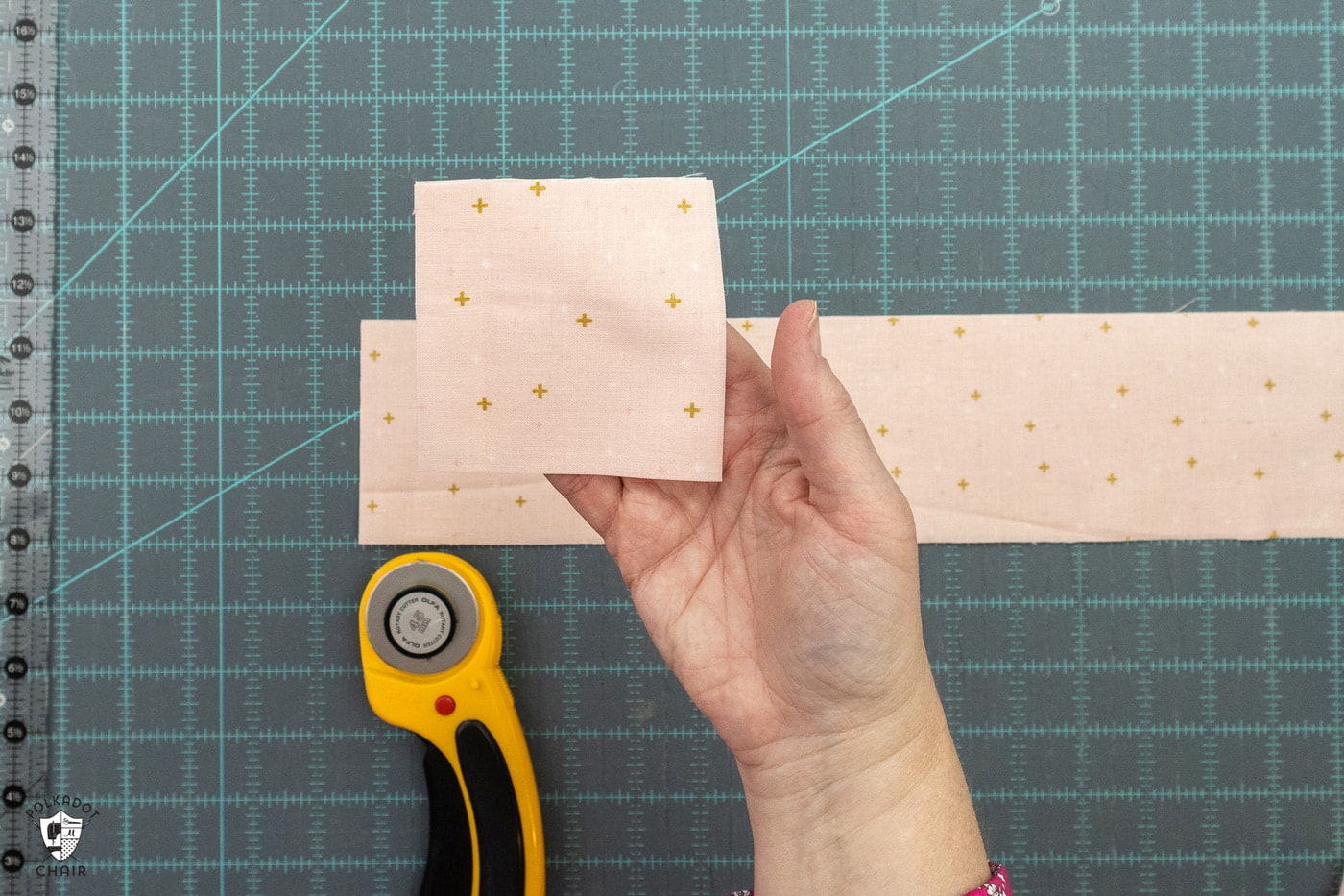 pink fabric being cut on blue cutting mat