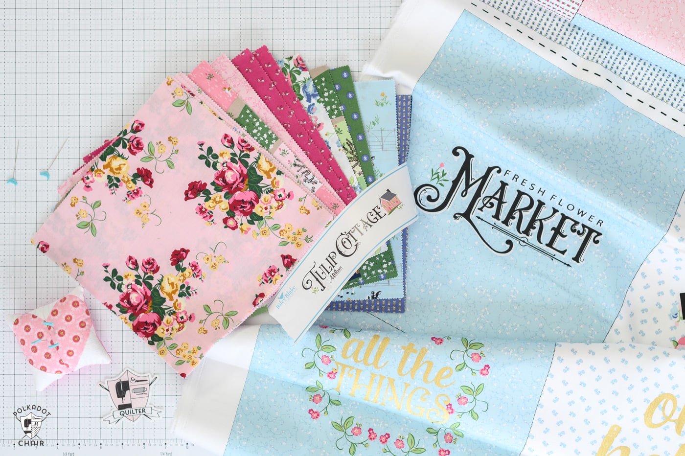 squares of colorful spring fabric on white cutting mat