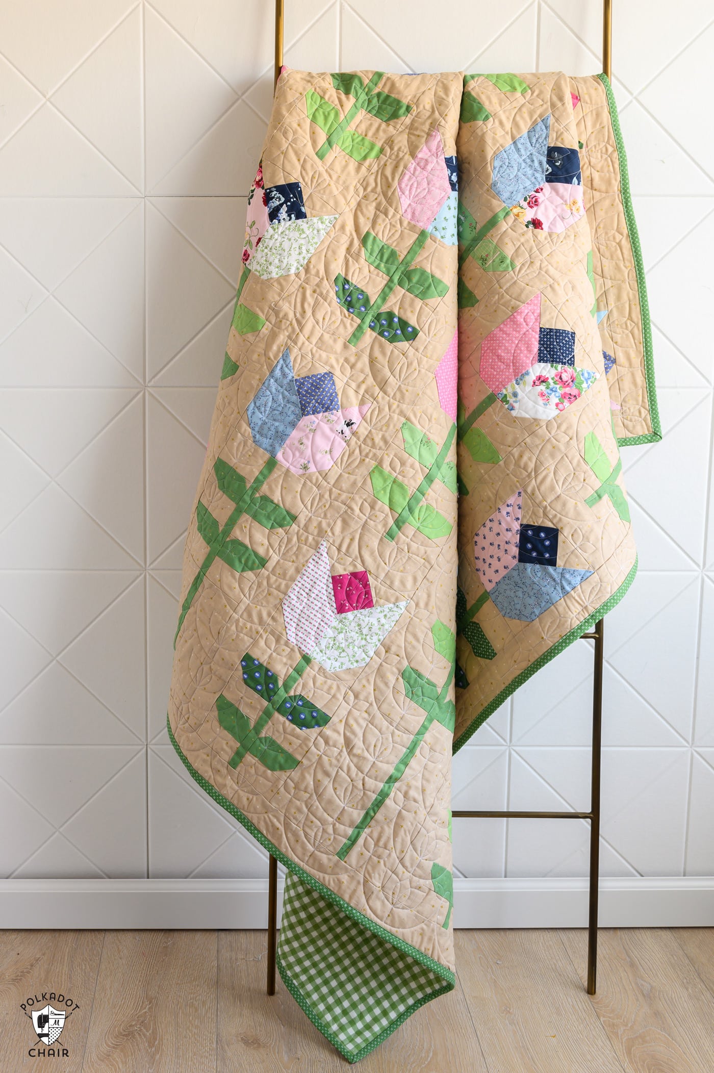 Tulip quilt on quilt ladder in front of white wall